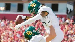  ?? CHARLIE NEIBERGALL/AP ?? Baylor’s Gavin Holmes celebrates with teammate Ben Sims, left, after catching a 38-yard touchdown pass against Iowa State on Saturday in Ames, Iowa.