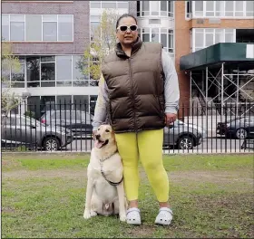  ?? (AP/Emma H. Tobin) ?? Suly Ortiz stands Tuesday with her yellow Labrador retriever, Ruben, at McCarren Park in Brooklyn. Ortiz described Ruben as “really calm, lazy and shy.”