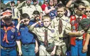  ?? JAKE MAY/THE FLINT JOURNAL — MLIVE.COM VIA AP ?? Boy Scouts and Cub Scouts salute during a Memorial Day ceremony in Linden, Mich. On Wednesday, the Boy Scouts of America board of directors unanimousl­y approved allowing girls into the Cub Scouts program starting in 2018.
