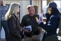  ?? (AP/The Gazette/Parker Seibold) ?? Custer County Sheriff Lloyd Rich Smith (center) speaks to a reporter outside of the Custer County Sheriff’s Office on Tuesday in Westcliffe, Colo.