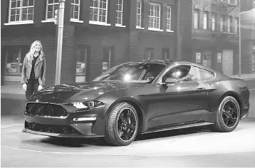  ??  ?? Molly McQueen, granddaugh­ter of iconic actor Steve McQueen, introduces the 2018 Ford Mustang Bullitt at its debut at the 2018 North American Internatio­nal Auto Show January 14, in Detroit, Michigan. — AFP photo