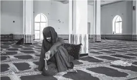  ?? NEW YORK TIMES PHOTO BY JIM HUYLEBROEK ?? Zaheer Ahmad Zindani, who was blinded five years ago by a roadside bomb, sits in a mosque in Ghazni, Afghanista­n. Zindani is one of the founders of a 400-mile peace march across Afghanista­n.