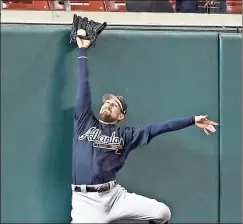  ?? Nick Wass / The Associated Press ?? Atlanta center fielder Ender Inciarte leaps up to make a catch during the third inning of Thursday’s game in Washington. The Nationals won 5-2.