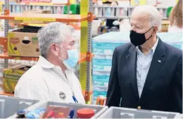  ?? PATRICK SEMANSKY/AP ?? President Joe Biden speaks with a Houston Food Bank volunteer Friday. Texas was hit particular­ly hard this month by a storm that battered multiple states.