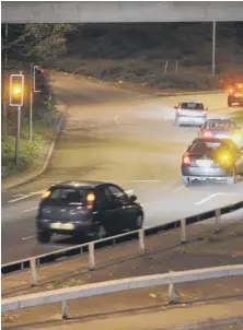  ??  ?? The driver of a blue Vauxhall prepares to run a red light on the A15 at Brotherhoo­d Roundabout, above, and goes through, top right