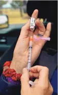  ?? JIM THOMPSON/JOURNAL ?? Paramedic Shannon Farrell fills a syringe with the Johnson & Johnson COVID-19 vaccine last month. New Mexico ranks among the top states with the highest percentage of its population vaccinated. As of Tuesday, nearly 31% of the population in New Mexico was fully vaccinated; slightly more than 48% had the first dose.