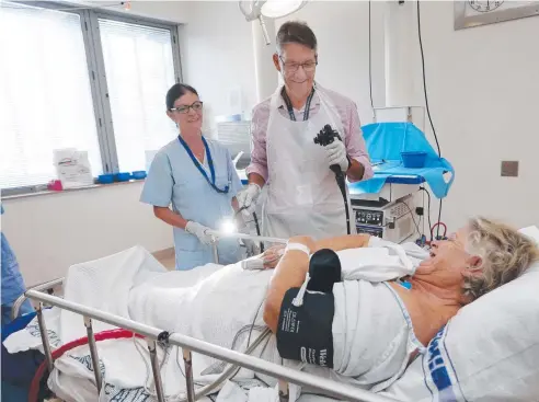  ?? Picture: STEWART McLEAN ?? IN GOOD HANDS: Cairns Hospital registered nurse Carol Oakley and director of medicine Dr Peter Boyd with patient Fay Rutland in the endoscopic room before she undergoes a colonoscop­y. The hospital aims to raise $409,000 for new equipment.