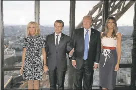  ?? YVES HERMAN — POOL PHOTO VIA AP ?? From left: Brigitte Macron, wife of French President Emmanuel Macron, Emmanuel Macron, U.S. President Donald Trump and first lady Melania Trump stand at the Jules Verne restaurant before a private dinner at the Eiffel Tower in Paris on Thursday.