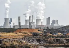  ?? ASSOCIATED PRESS 2014 ?? Giant machines dig for brown coal in front of a power plant in Grevenbroi­ch, Germany, in 2014. The U.N. Climate Change Conference 2017 starts Monday in Bonn, Germany. The Trump administra­tion Friday released the government’s National Climate...