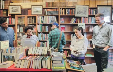  ?? Photograph­s by Irfan Khan Los Angeles Times ?? AMID THE aisles of Caravan Book Store, browsing meant exploring, and ignorance was a door opening onto the unexpected.