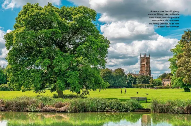  ??  ?? A view across the still, glassy water of Abbey Lake, fed by the River Churn, over the pastoral centrepiec­e of Cirenceste­r, the Abbey Grounds, to St John Baptist church tower.