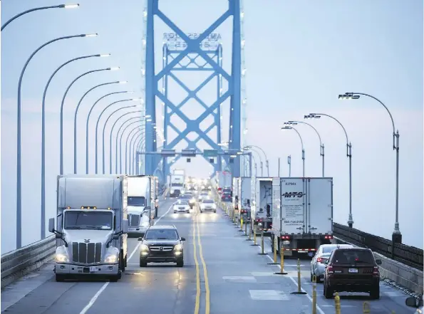  ?? COLE BURSTON/BLOOMBERG ?? Commercial trucks and passenger vehicles drive across the Ambassador Bridge in Windsor, Ont. A National Associatio­n for Business Economics survey found that 91 per cent of respondent­s believe U.S. threats of additional tariffs were affecting the economy negatively.