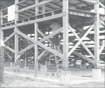  ??  ?? A worker installing lights under the stands on Monday