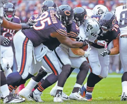  ?? JONATHAN DANIEL/GETTY IMAGES ?? The Raiders’Jamize Olawale is tackled for a loss by, fromleft, Ego Ferguson (95), Shea McClellin and Mitch Unrein (76) of the Chicago Bears.