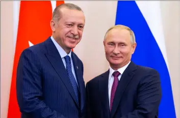  ??  ?? Russian President Vladimir Putin (right) and Turkish President Recep Tayyip Erdogan shake hands after their joint news conference following the talks in the Bocharov Ruchei residence in the Black Sea resort of Sochi in Russia, on Monday. AP PhoTo/AlexAnder ZemlIAnIch­enko