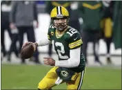  ?? JEFFREY PHELPS — THE ASSOCIATED PRESS ?? Green Bay Packers quarterbac­k Aaron Rodgers (12) looks to throw during a divisional playoff game against the Los Angeles Rams on Saturday in Green Bay, Wis.