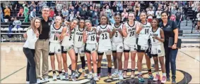  ?? Tim Godbee ?? Members of the Calhoun girls basketball team, including head coach Jaime Echols and assistant coaches Tess Wright and Michelle Gregoire, show they are headed to the GHSA 5A Final Four state playoffs after a solid 62-52 victory over Arabia Mountain Tuesday night in the state quarterfin­als at The Hive.