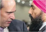  ??  ?? Guy Caron, left, and Jagmeet Singh speak Sunday in Toronto at the federal NDP meeting where Singh won the party leadership.