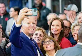  ?? Evan Vucci / Associated Press ?? President Joe Biden takes a photo with supporters after speaking about his 2024 budget proposal, which would cut deficits by $2.9 trillion over the next decade, in Philadelph­ia on Thursday.