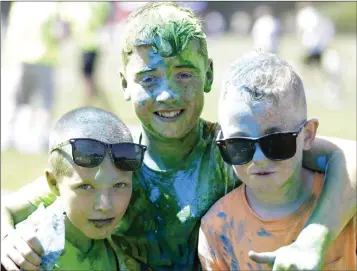  ??  ?? Sean O’Brien, Daryll Murray and Cian Kinlan having fun at the Ardmore Rovers Colour Rush run at Ballywaltr­im Park.