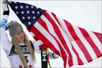  ?? GIOVANNI AULETTA — THE ASSOCIATED PRESS ?? Third place finisher Lindsey Vonn celebrates on the podium after the women’s downhill race, at the alpine ski World Championsh­ips in Are, Sweden, Sunday.