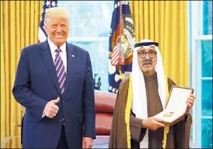  ?? KUNA photos ?? Left: HH the Amir’s representa­tive Sheikh Nasser Sabah Al-Ahmad Al-Jaber Al-Sabah and other officials pose with US President Donald Trump before the awarding of the Legion of Merit to HH the Amir. (Right): Sheikh Nasser
Sabah displays the Legion of Merit awarded to HH the Amir by US President Donald Trump.