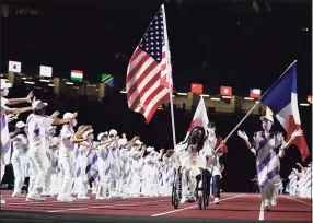  ?? Shuji Kajiyama / Associated Press ?? Flag bearers for the United States, Japan and France enter the stadium during the closing ceremony for the 2020 Paralympic­s at the National Stadium on Sunday.