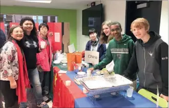  ?? ANNIE HOU / CHINA DAILY ?? Beijing 101 High School visiting students and teachers, together with their buddies from Westminste­r, make dumplings and other traditiona­l Chinese New Year cuisine for the Westminste­r School’s “Around the World in 80 Bites” event on Feb 4, an...