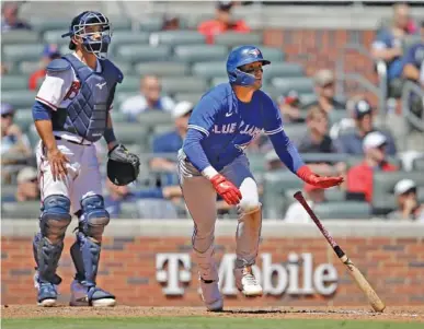  ?? AP PHOTO/BEN MARGOT ?? The Toronto Blue Jays’ Bo Bichette drops his bat after hitting an RBI double in the ninth inning of Thursday’s game against the host Atlanta Braves. The Blue Jays rallied for four runs in the ninth to win 8-4 and sweep the season series with Atlanta.