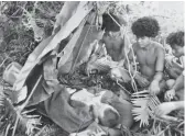  ??  ?? In the war zone … ‘ fuzzy wuzzy angels’ taking care of a World War 2 soldier.