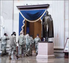  ?? Getty Images ?? Members of the National Guard walk through the rotunda of the U.S. Capitol on Monday in Washington, D.C.