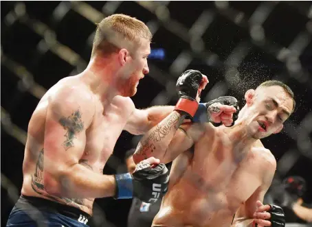  ?? Reuters ?? Justin Gaethje lands a left to the jaw of Tony Ferguson during their bout at UFC 249 on Saturday at VyStar Veterans Memorial Arena.