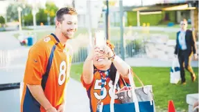  ?? Greg McBoat, Special to The Denver Post ?? Brandon McManus takes a photo with a fan at the Taste of the Broncos on Sept. 18, 2017.