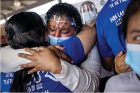  ??  ?? A Honduran asylum seeker has an emotional reunion with a church volunteer upon arrival to the US in Brownsvill­e, Texas, on 26 February 2021. Photograph: John Moore/Getty Images