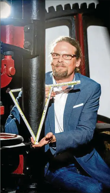  ??  ?? Erfinder Mario Neugärtner demonstrie­rt seinen Zollstock, mit dem man auch Rundes messen kann. Fotos: Sascha Fromm