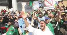  ??  ?? People carry national flags and banners during a protest demanding the removal of Algeria’s ruling elite in Algiers, Algeria. — Reuters photo