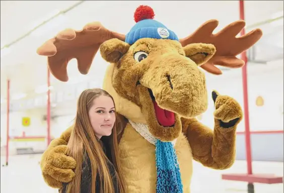  ?? Photos by Will Waldron / Times Union ?? Adirondack Mac, the mascot for the 2023 FISU World University Games in Lake Placid, hugs Kristina Ingerowski, a Fashion Institute of Technology sophomore who designed Mac. Ingerowski, of Farmington, Ontario County, won a $5,000 cash prize for her artistic efforts.