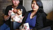  ?? EMILY MICHOT / MIAMI HERALD ?? Justin Johnson and his girlfriend Rebecca Sanders, a Miccosukee Indian, hold pictures of their baby, Ingrid, who was taken from Baptist Hospital by Miccosukee police. A tribal court agreed Thursday to return the baby to her parents.