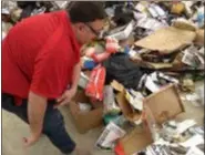  ?? FRAN MAYE - MEDIANEWS GROUP ?? Scott Mengle, general manager of SECCRA, looks over pizza boxes that were improperly sent to recycling.