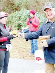  ?? Keith Bryant/The Weekly Vista ?? Stacy Middleton receives a piece of wood from mayor Peter Christie after finishing Saturday’s 10K trail run.