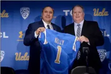  ??  ?? New UCLA head football coach Chip Kelly (right) and Director of Athletics Dan Guerrero pose for a photo during a news conference on the UCLA campus at Pauley Pavilion on Monday. AP PHOTO