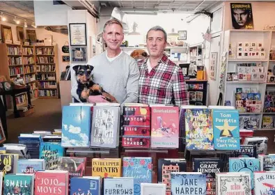  ?? Arnold Gold/Hearst Connecticu­t Media ?? Breakwater Books owners Richard Parent, left, and Paul Listro are photograph­ed in the store on Whitfield Street in Guilford on Feb. 10. Parent is holding their dog, Barney.