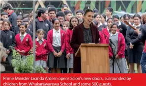  ??  ?? Prime Minister Jacinda Ardern opens Scion’s new doors, surrounded by children from Whakarewar­ewa School and some 500 guests.