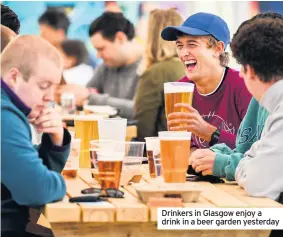  ??  ?? Drinkers in Glasgow enjoy a drink in a beer garden yesterday