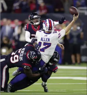  ?? MICHAEL WYKE - THE ASSOCIATED PRESS ?? Buffalo Bills quarterbac­k Josh Allen (17) tries to throw a pass as he is tackled by Houston Texans’ Whitney Mercilus (59), A.J. Moore Jr., right, and Vernon Hargreaves III (28) during the second half of an NFL wild-card playoff football game Saturday, Jan. 4, 2020, in Houston.