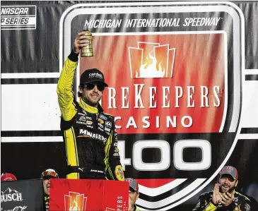  ?? CARLOS OSORIO/ASSOCIATED PRESS ?? Ryan Blaney celebrates his squeaker of a victory in the NASCAR Cup Series race at Michigan Internatio­nal Speedway on Sunday in Brooklyn, Mich.