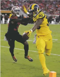  ?? BEN MARGOT/THE ASSOCIATED PRESS ?? Rams running back Todd Gurley scores a touchdown past 49ers defender Ray-Ray Armstrong on Thursday during Los Angeles’ 41-39 win in Santa Clara, Calif.