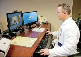  ?? [PHOTO BY BRYAN TERRY, THE OKLAHOMAN] ?? Dr. Robert Rader talks with registered nurse Cathy Koehn at Fairview Regional Medical Center on Tuesday as they demonstrat­e St. Anthony’s telemedici­ne in Oklahoma City.