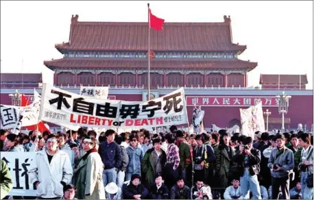  ?? CATHERINE HENRIETTE/AFP ?? Students and people gathered at Tiananmen Square in Beijing on May 14, 1989, after an over-night hunger strike as part of the mass pro-democracy protest against the Chinese government.