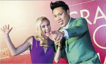  ?? DON WONG/ THE ASSOCIATED PRESS ?? Director John M. Chu and his wife Kristin Hodge arrive for the première of Crazy Rich Asians in Singapore.